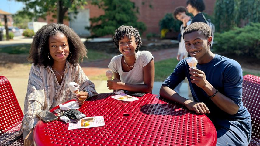 students eating ice cream at picnic table